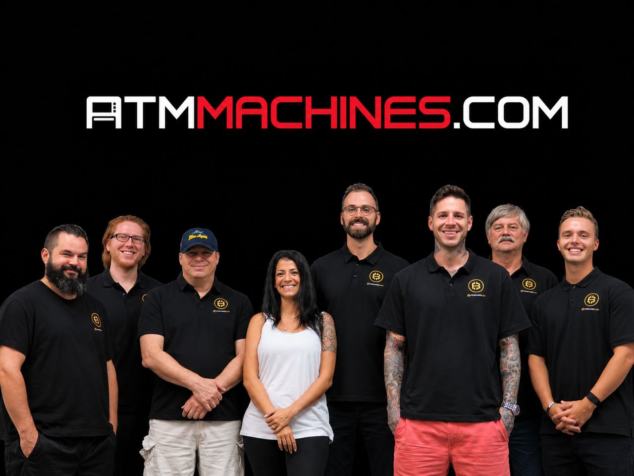 Justin Gilmore standing with eight members of the ATMMachines.com team, all in company shirts